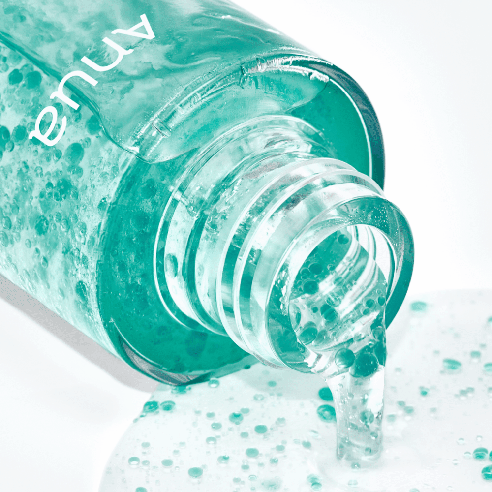 Anua skincare product on ground with skincare capsule texture