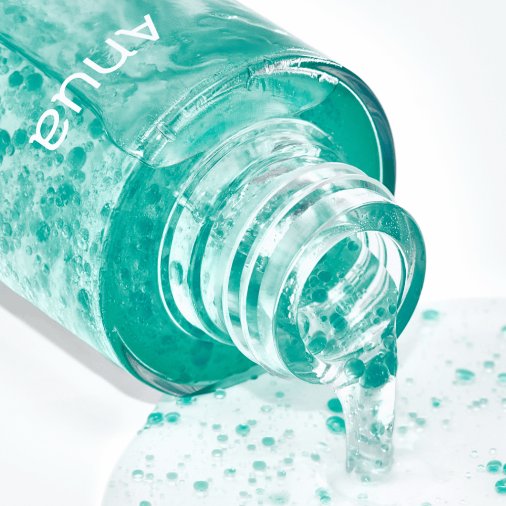 Anua skincare product on ground with skincare capsule texture