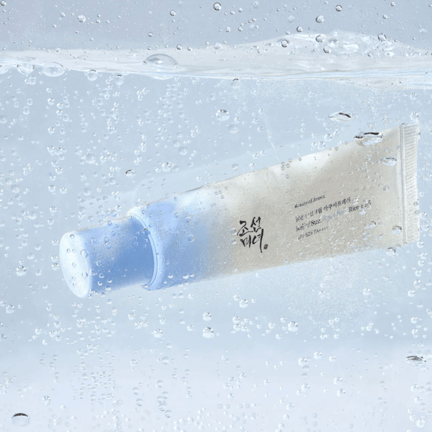Korean suncream bottle on bright blue background