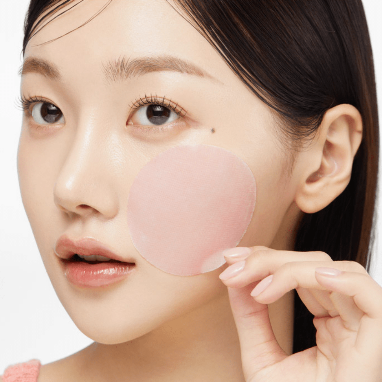BHA toner pad being applied to acne-prone skin