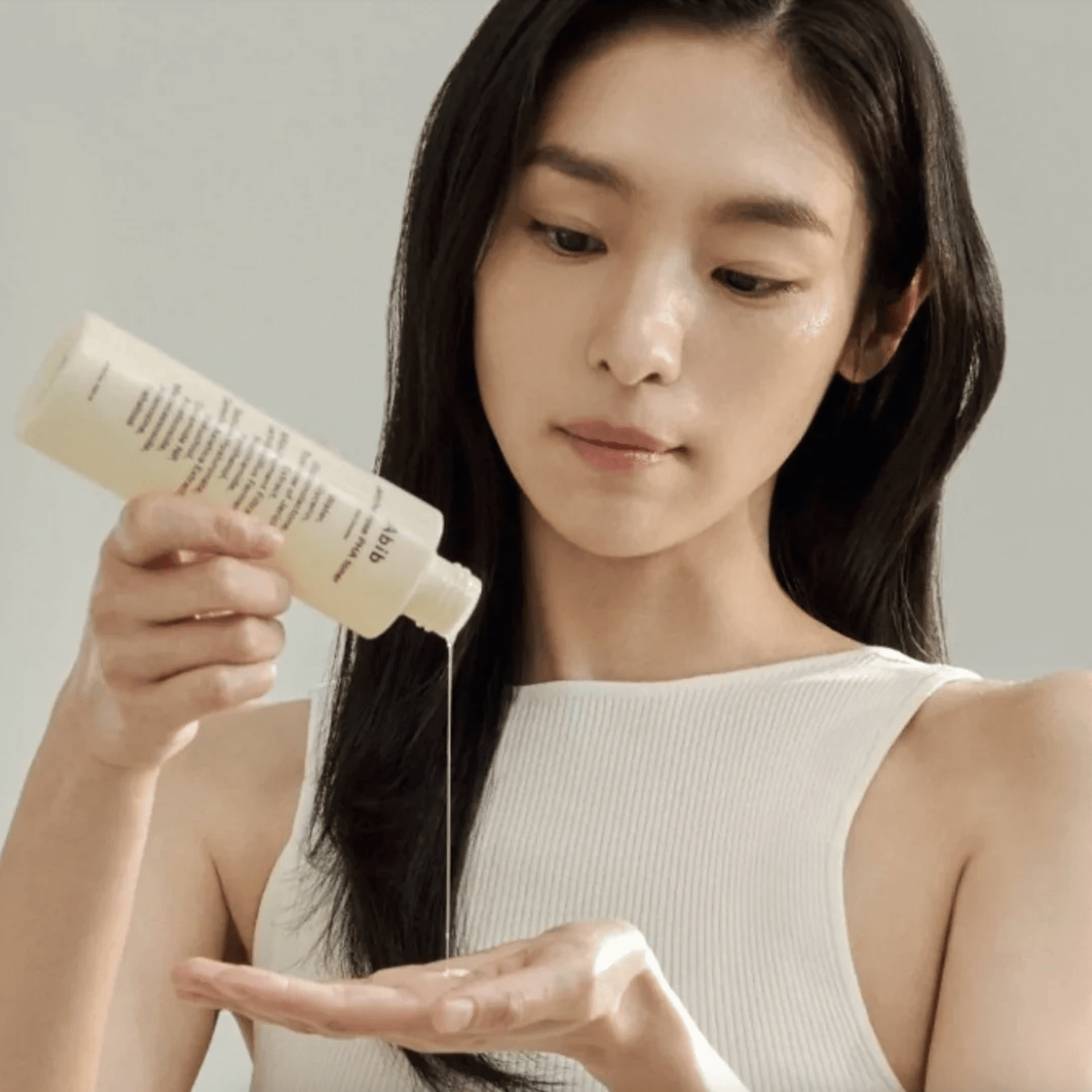 Women apply abib toner on hand