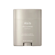Grey sunstick container with ABIB Airy Sunstick Smoothing bar branding on a white background