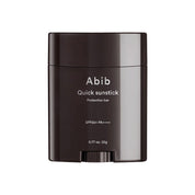 Black sunstick container with ABIB Quick Sunstick Protection bar branding on a white background