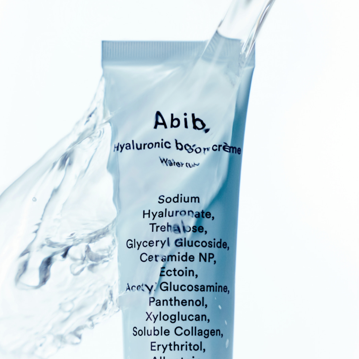 Product packaging with 'Abib' branding and ingredient list, surrounded by water droplets.