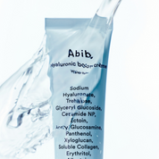 Product packaging with 'Abib' branding and ingredient list, surrounded by water droplets.