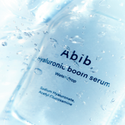 Abib hyaluronic boorn serum packaging with water droplets on a white background