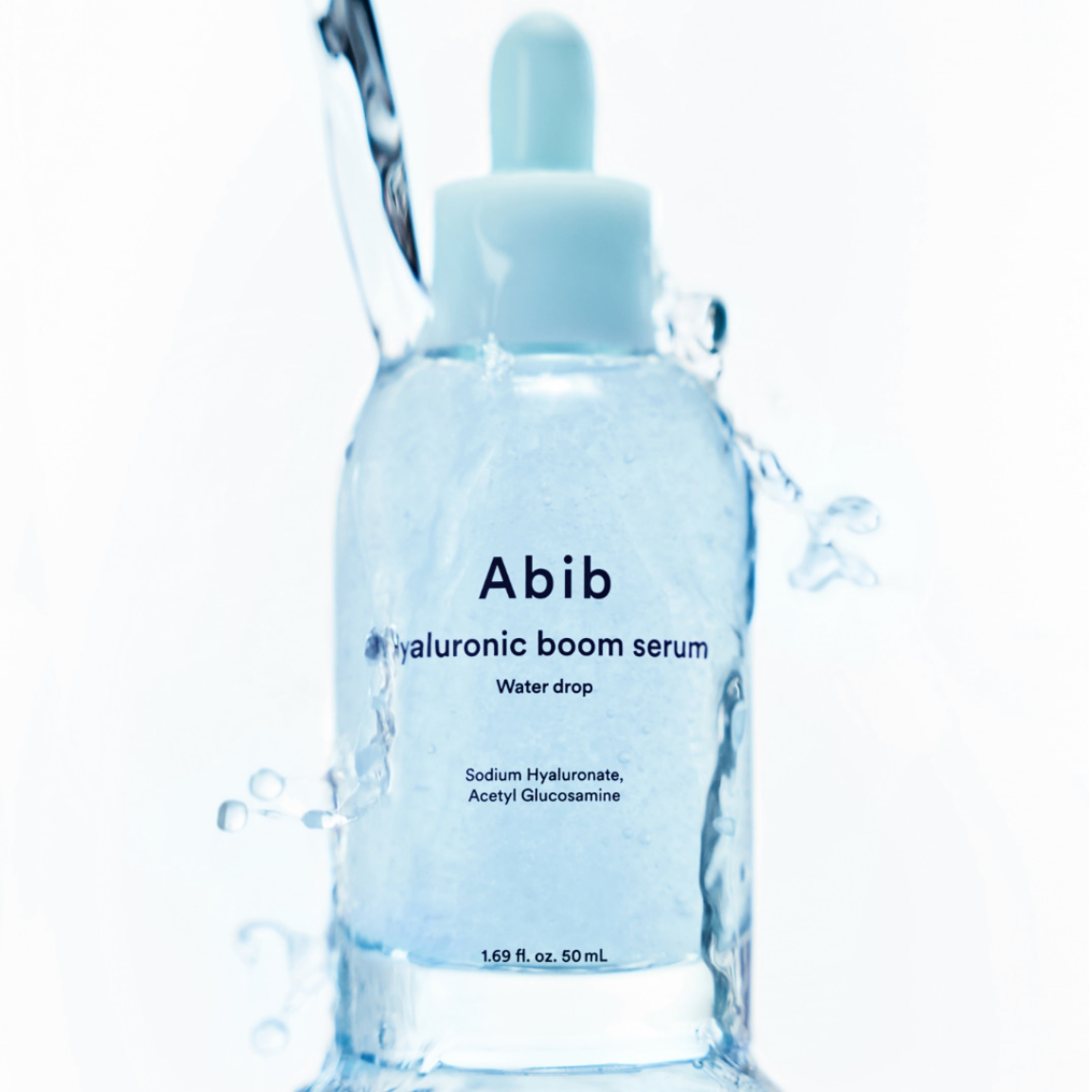 Hyaluronic boom serum bottle with water droplets on a white background