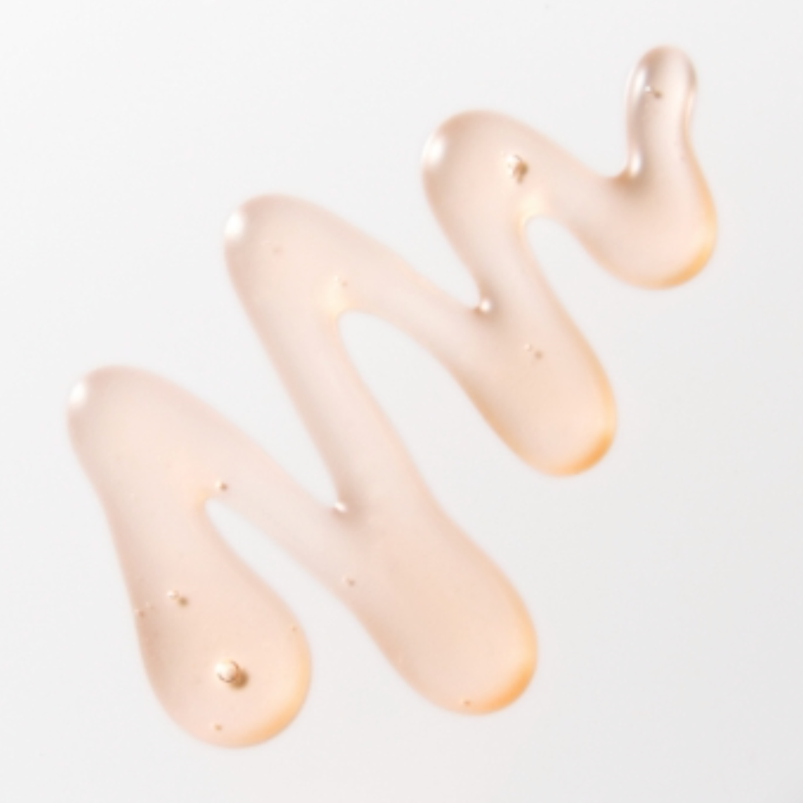 Close-up of beige cream or lotion on a light background