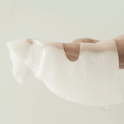 ABIB Collagen Gel Beauty Mask Jericho Rose Jelly held by a person against a light background