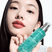 Woman holding a green skincare bottle with 'ANUA' branding.
