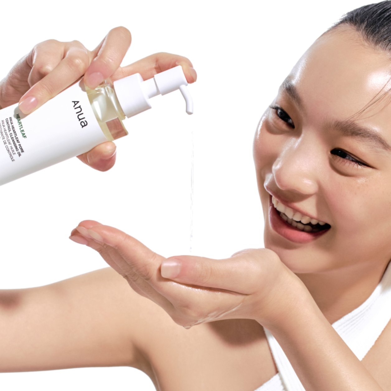Women holding ANUA-Heartleaf-Pore-Control-Cleansing-Oil bottle and dropping on the hand