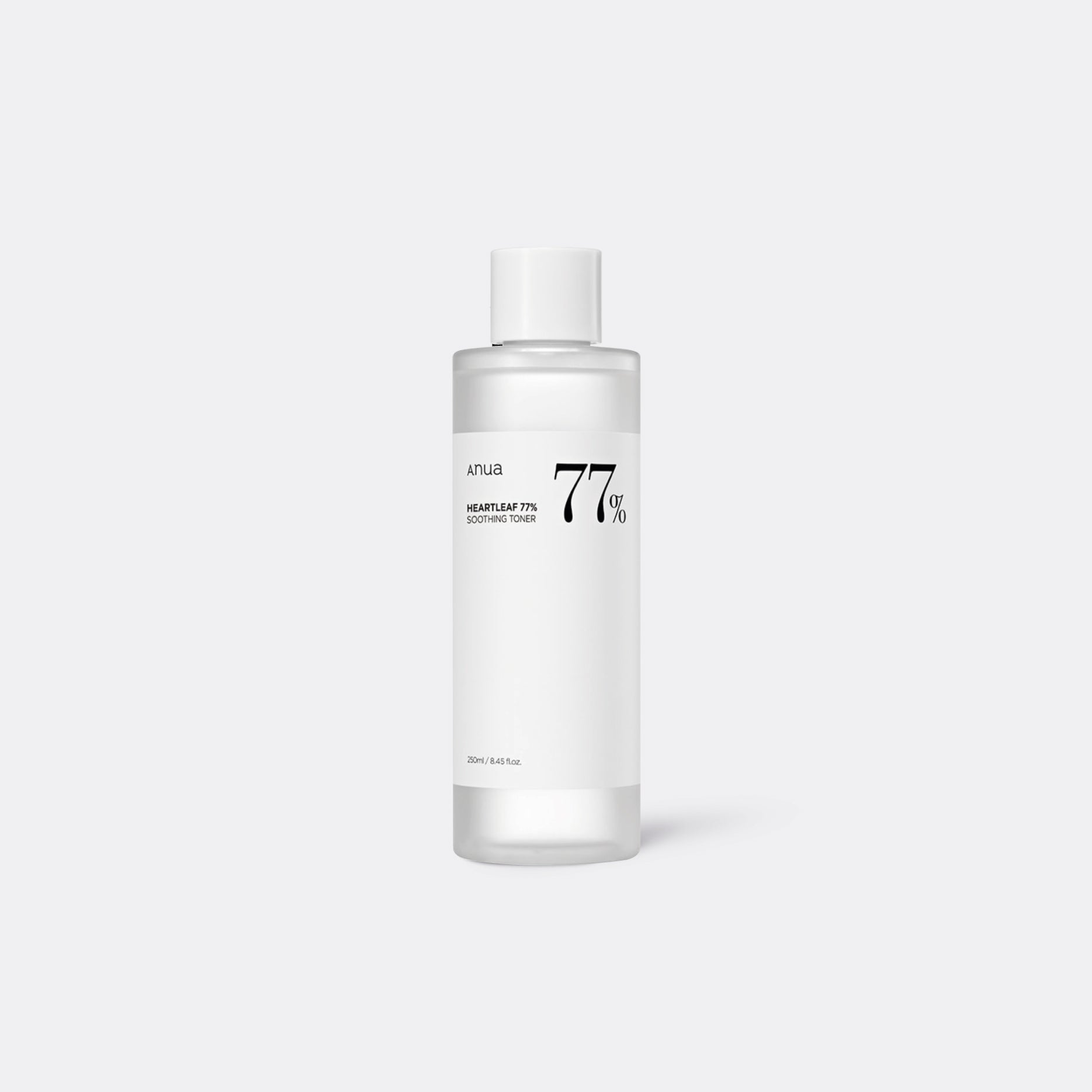 A clear bottle containing a white liquid with a label indicating ANUA Heartleaf 77% Soothing Toner. The bottle is on a white background.