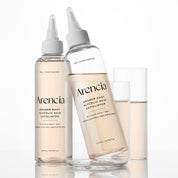 Two clear ARENCIA Eraser Shot Glycolic Acid Exfoliator with white dropper-style caps and two clear drinking glasses on a white background. The bottles are labeled Arencia Eraser Shot Glycolic Acid Exfoliator and Peel Toner Essence.