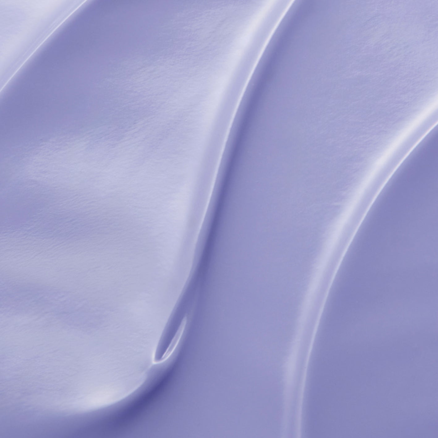 Close-up of a smooth, light purple surface with soft shadows