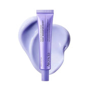 Purple skincare product tube with a swatch of the product on a white background
