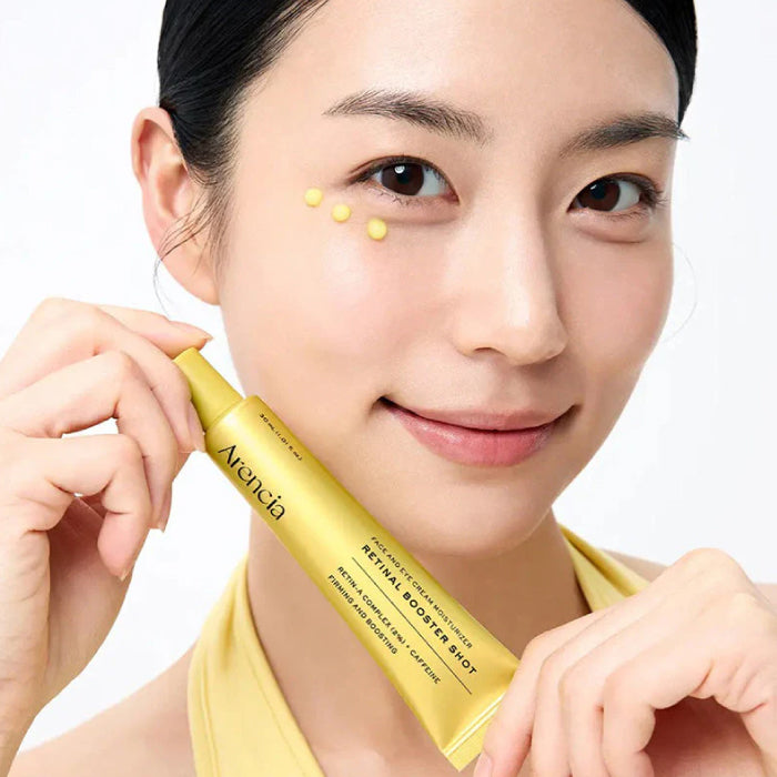 Woman holding a ARENCIA Retinal Booster Shot with a white background