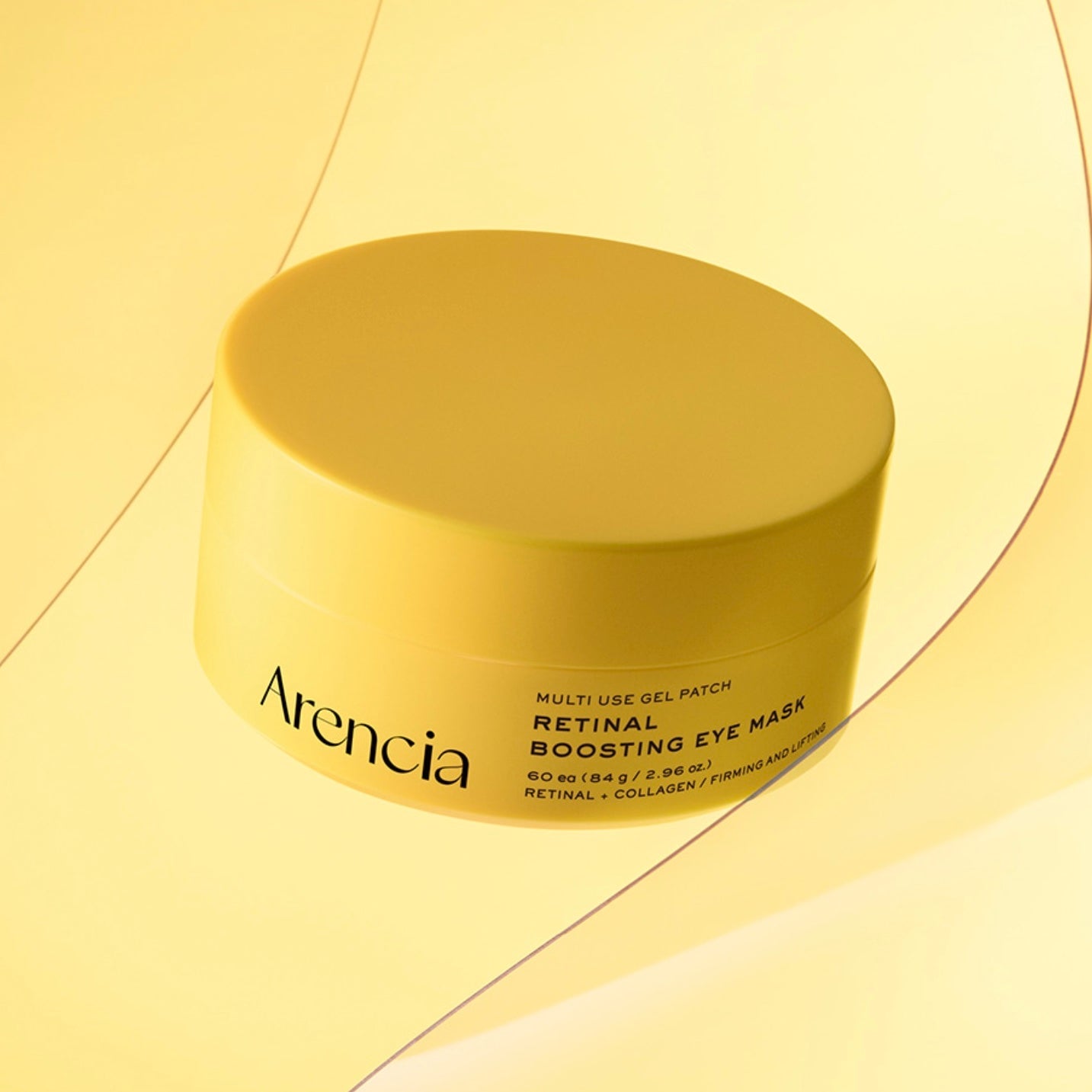 A yellow jar of Arencia Retinal Boosting Eye Mask on a matching yellow background with abstract curved lines.