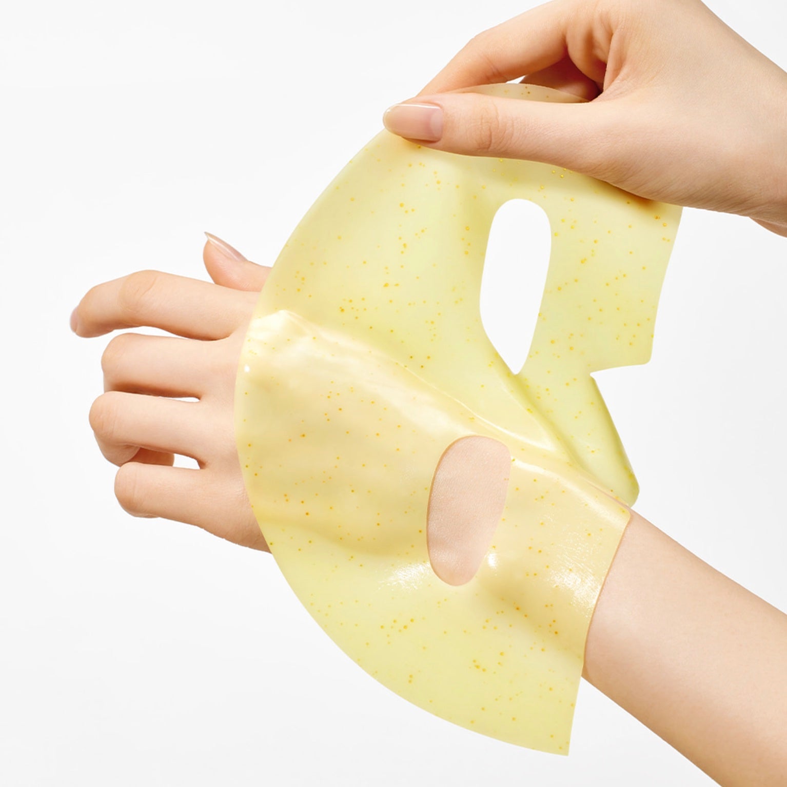ARENCIA Vita Collagen Radiance Jello with tiny gold speckles being held by two hands against a clean white background.