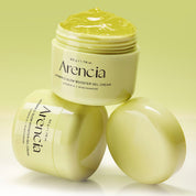 Three jars of Arencia Vitamin C Glow Booster Gel Cream arranged on a light yellow-green background, with one open jar showing the gel cream on top and two closed jars beside it.