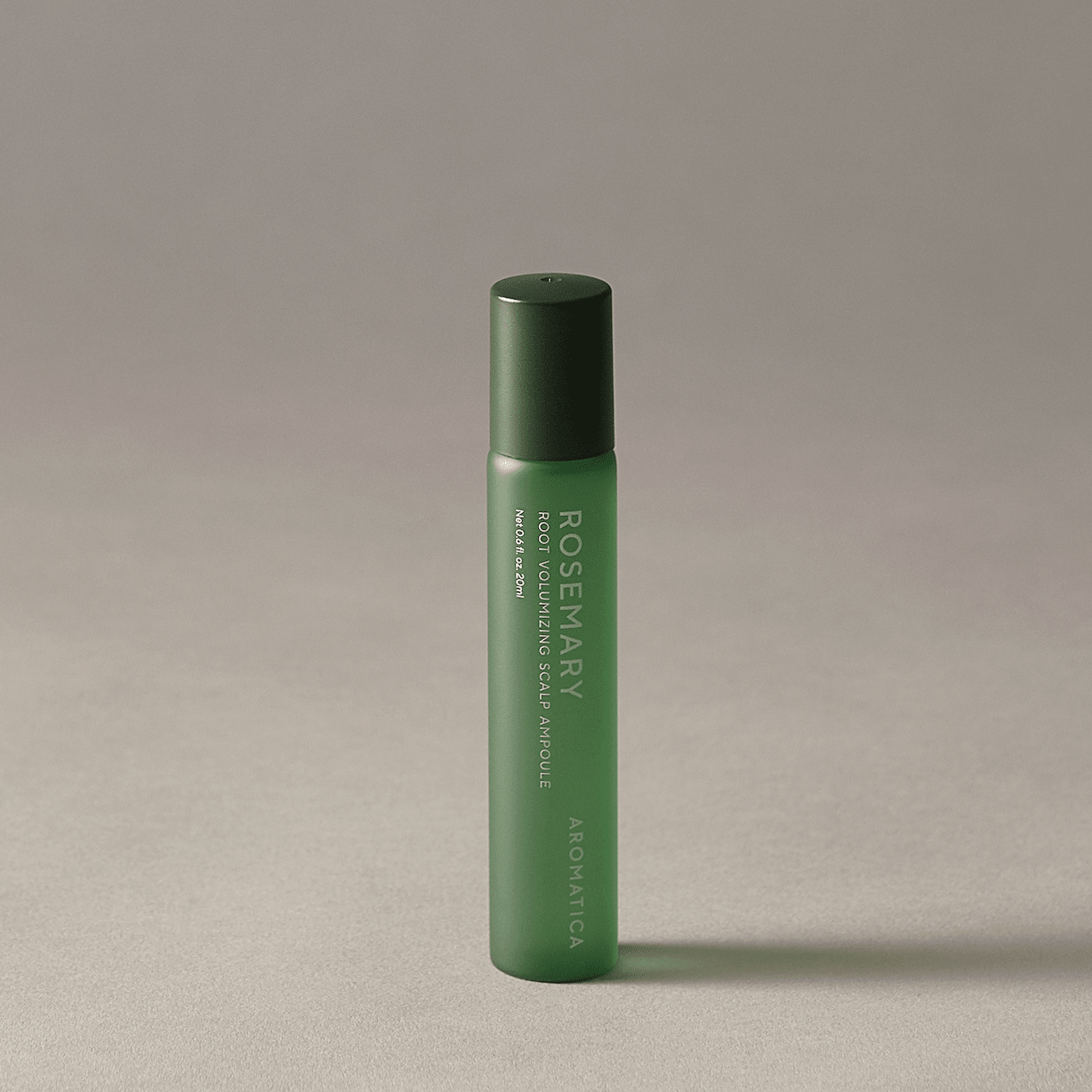 AROMATICA Rosemary Root Volumizing Scalp Ampoule with black cap on a beige background