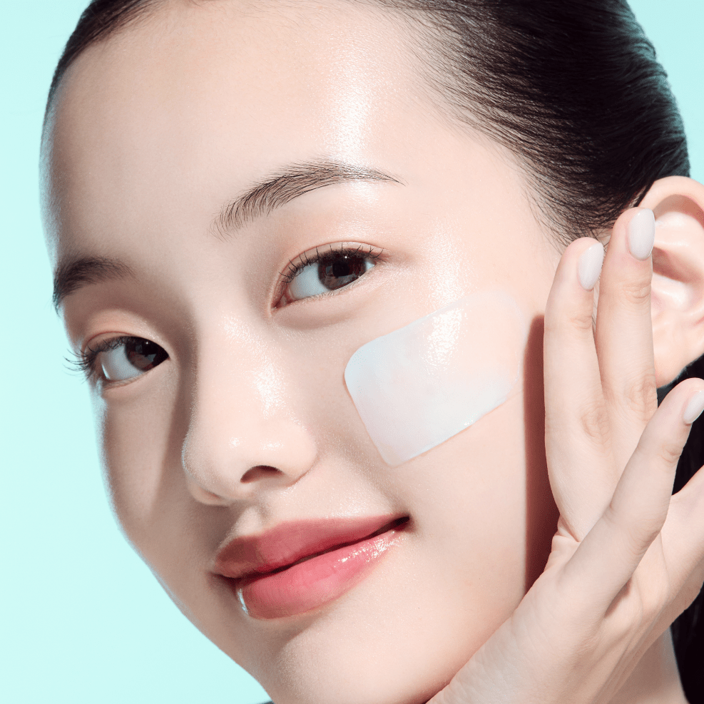 Woman applying ANUA PDRN Hyaluronic Acid Moisturizing Cleansing Foam with a light blue background