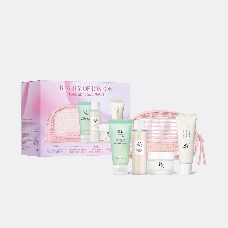 Beauty of Joseon Glow Skin Essential Kit featuring a pink zippered pouch, skincare tubes, bottles, and jars arranged in front of its pink and white packaging box on a light gray background.