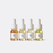 Beauty of Joseon serums four dropper bottles with different colored liquids on a white background