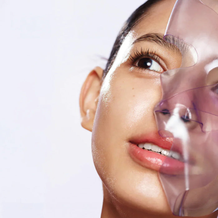 Woman using a Biodance Rejuvenating Caviar PDRN Real Deep Mask on a white background