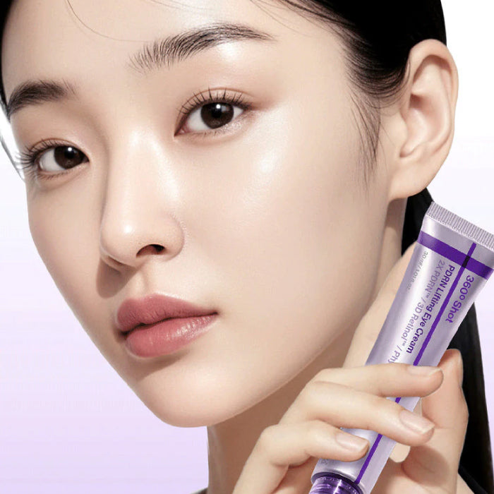Close-up of a person holding a CENTELLIAN24 360º Shot PDRN Lifting Eye Cream with a soft focus background