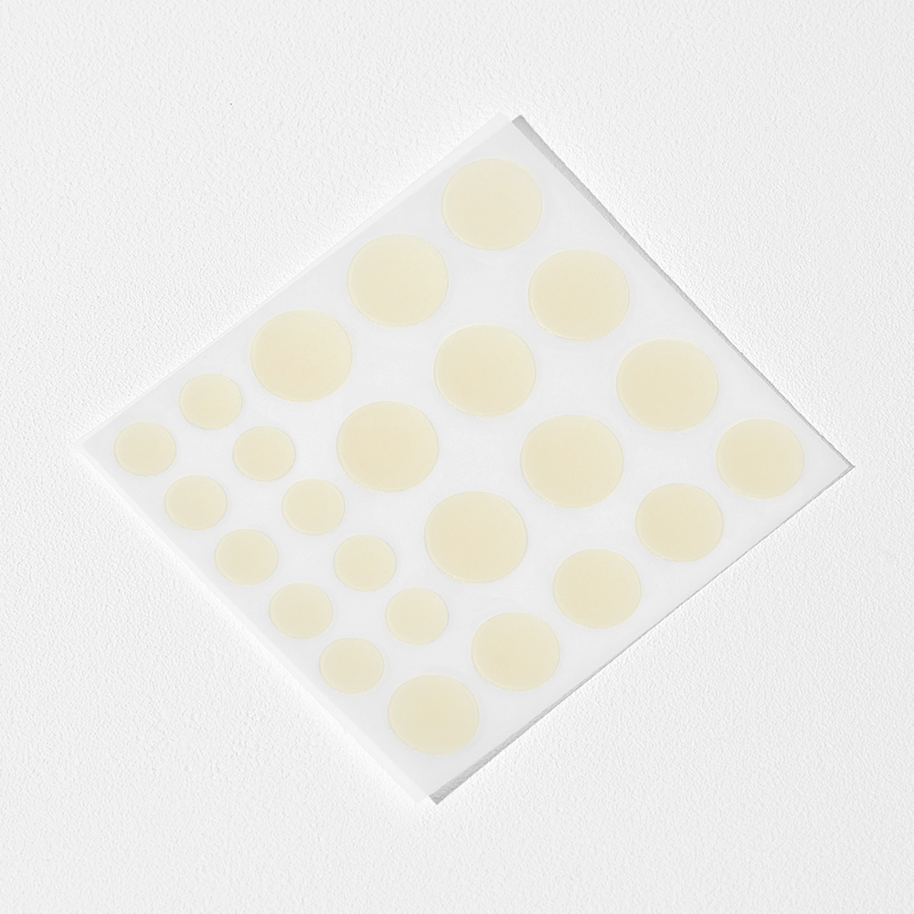 COSRX Acne Pimple Master Patch Sheet of round yellow stickers on a white background