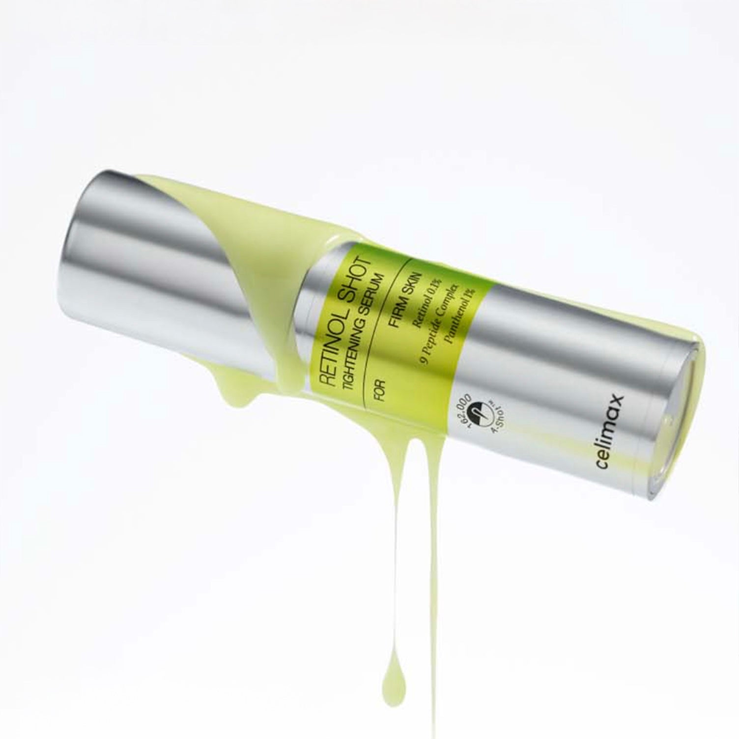 yellow liquid dropping on Celimax The Vita A Retinol Shot Tightening Serum bottle on white background