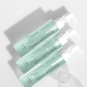 Three green DR. ALTHEA Gentle Pore Cleansing Oil bottles with text on a white background