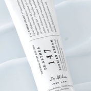 Dr. Althea 147 Barrier Cream tube with label on a cream texture background