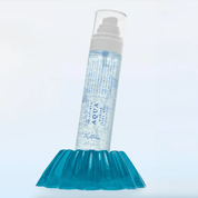 Dr. Althea Aqua Marine Jelly Mist bottle labeled 'Aqua' on a blue textured stand with a light gray background