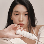 Women holding the Dr.Althea 345 Relief Cream Mist bottle in front of her face