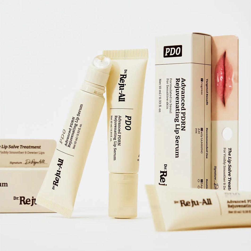 Dr. Reju-All Advanced PDRN Rejuvenating Lip Serum (10ml)  and lip salve treatment set, featuring cream-colored tubes, boxes, and a lip salve stick on a clean white background.