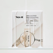 A white rectangular product box for Reju-All Advanced PDRN Rejuvenating Mask, shown on a white background with printed product details and a magnifying circle graphic over a cream tube.