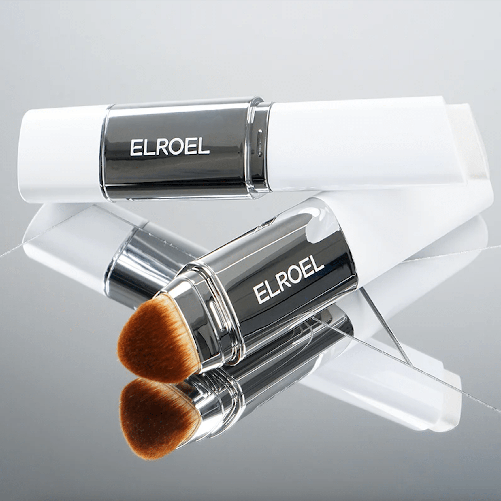 ELROEL Blanc Cover Cream Stick with white handles and brown bristles, branded 'ELROEL', on a light gray background.