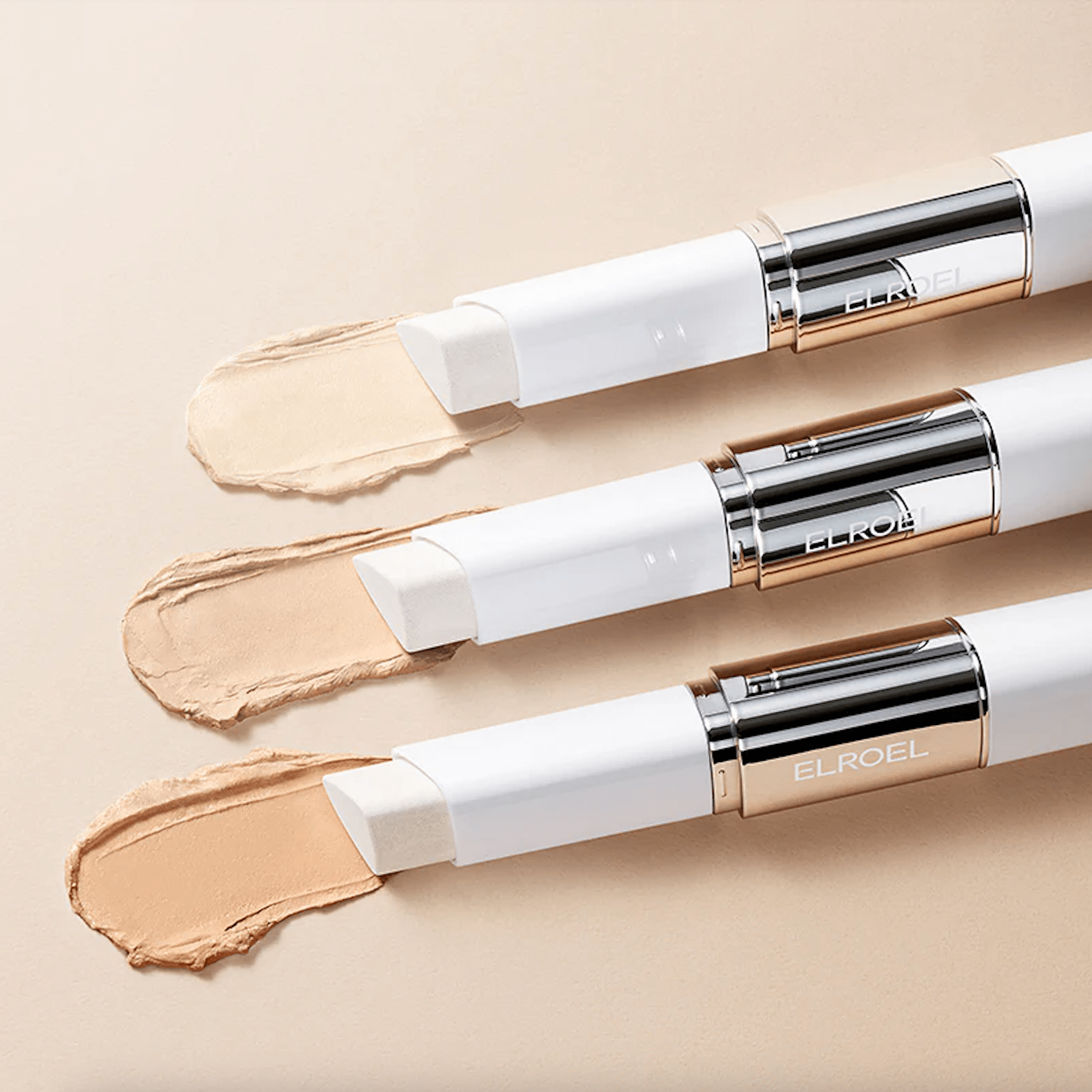 Three ELROEL Blanc Cover Cream Stick cosmetic sticks with visible Elroel branding on a beige background