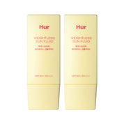 Two bottles of Hur Weightless Sun Fluid on a white background