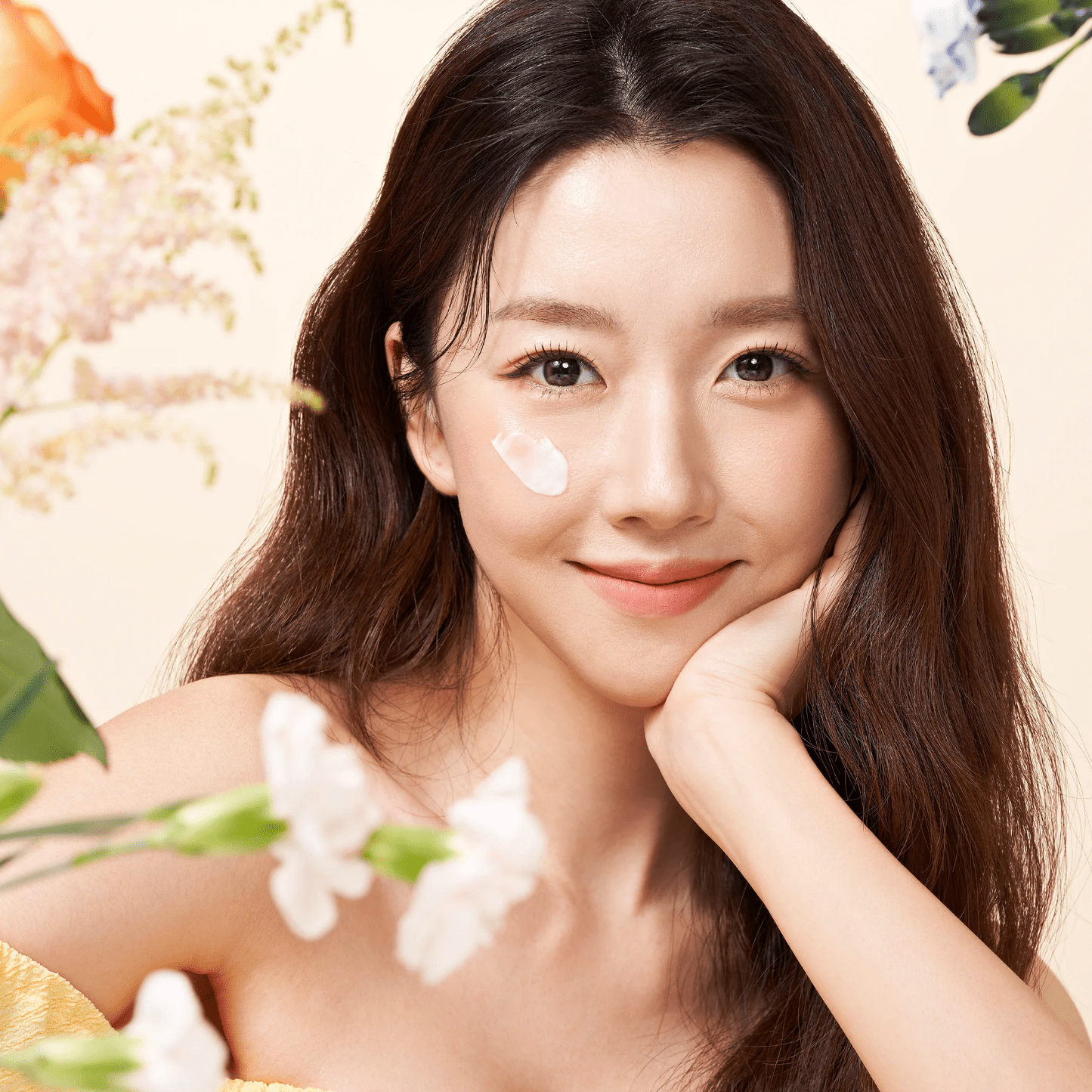 Woman with a light makeup look surrounded by flowers