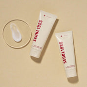 Two tubes of K-SECRET Seoul 1988 Cream: Snail Mucin 93% + Rice on a beige background
