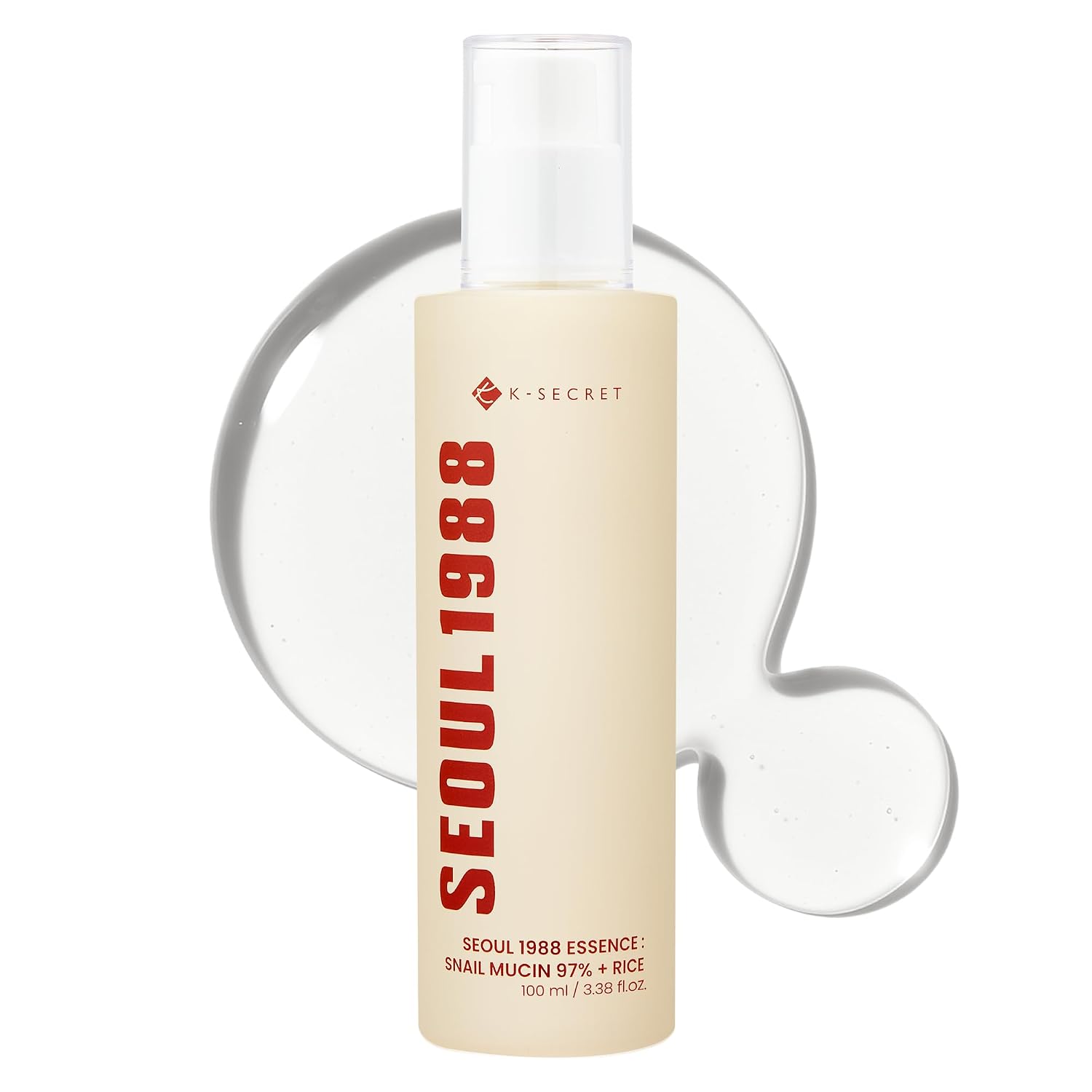 A 100 ml bottle of K-SECRET SEOUL 1988 Essence Snail Mucin 97% + Rice, featuring a cream-colored label with bold red text, set against a white background with a translucent clear gel splash behind it.