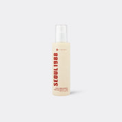 A bottle of K-SECRET SEOUL 1988 Essence Snail Mucin 97% + Rice  in a pale cream color with bold red text, shown on a light gray background.