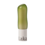 Green lip balm with white base on a white background