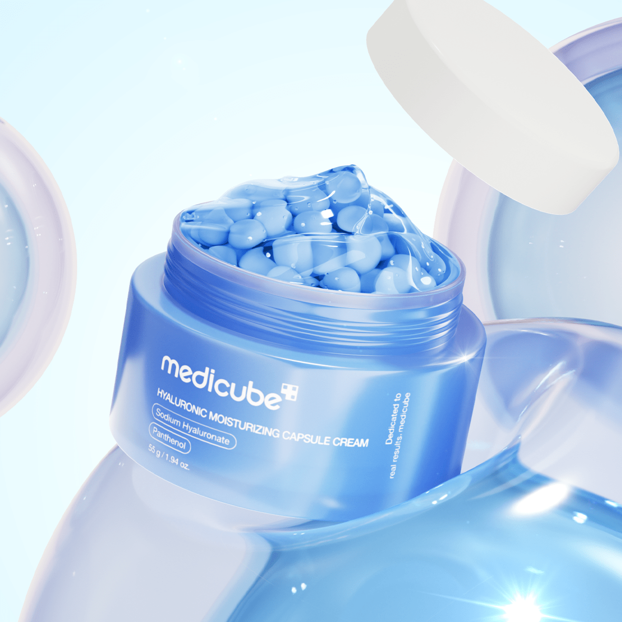 Blue jar of Medicube Hyaluronic Moisturizing Capsule Cream 55g moisturizing capsules surrounded by water droplets