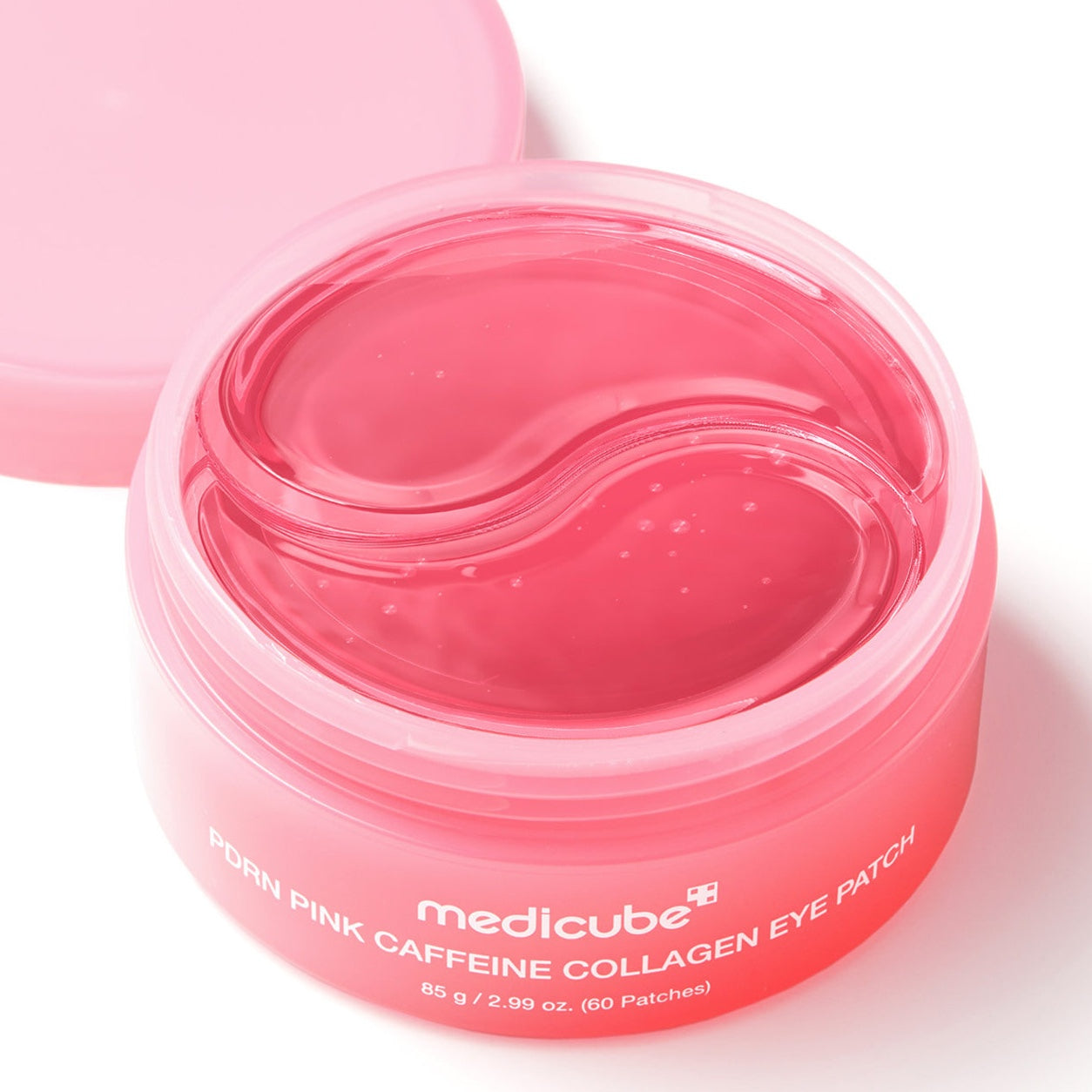A pink cosmetic jar of MEDICUBE PDRN Pink Caffeine Collagen Eye Patch with the lid off, showing the translucent pink eye patch inside, on a white background.