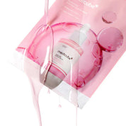 Medicube skin serum in a clear dropper bottle, shown with a pink sheet mask and liquid gel dripping over it on a white background.