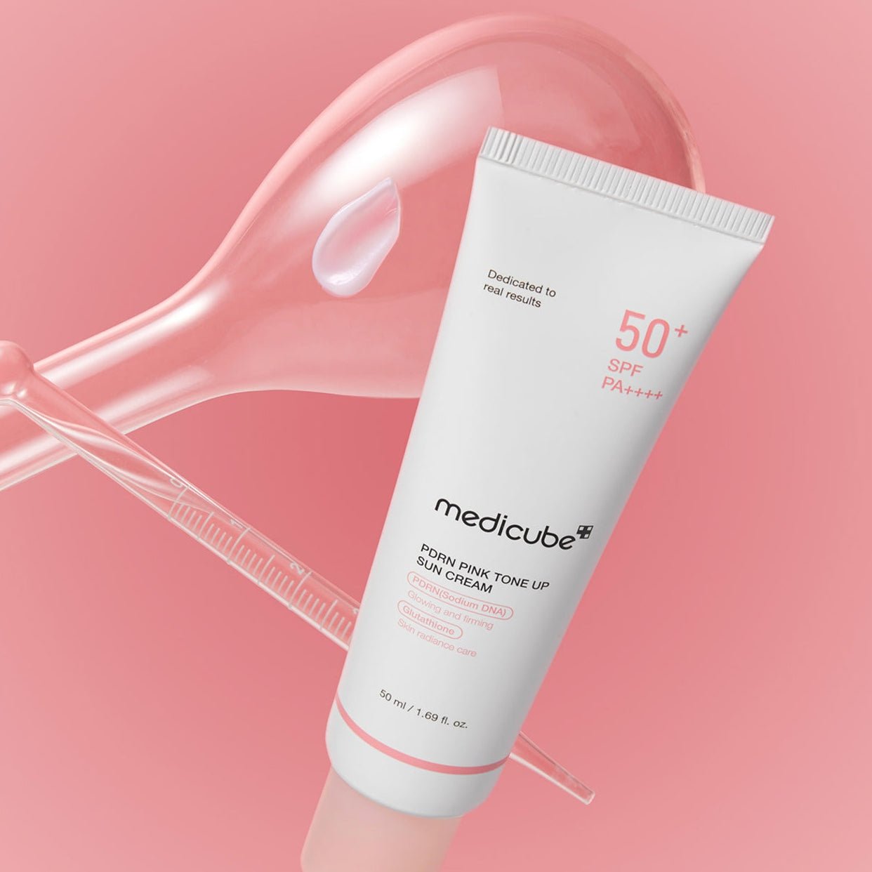 Tube of Medicube sun cream on a pink background