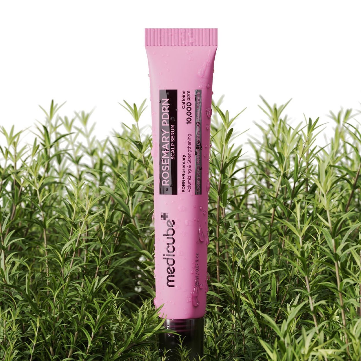 Pink tube of MEDICUBE Rosemary PDRN Scalp Serum in front of green plants